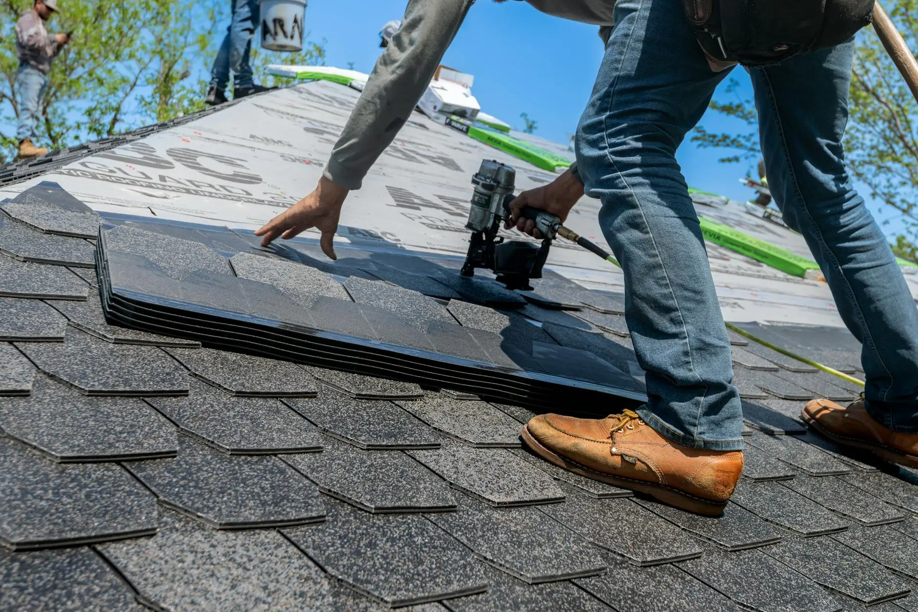 Witten Roofing crew installing architectural shingles on a multi-family commercial building in Louisville.